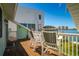Expansive water views enjoyed from the balcony with comfortable seating, a perfect spot to relax at 118 Wall St, Redington Shores, FL 33708
