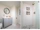 Bathroom showcasing gray vanity and a shower with white subway tiles and decorative niches at 118 Wall St, Redington Shores, FL 33708