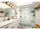 Modern bathroom featuring a glass-enclosed shower with subway tile and a patterned floor, plus a stylish vanity at 118 Wall St, Redington Shores, FL 33708