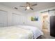 Comfortable bedroom with a ceiling fan, double closets, and a modern TV mounted on the wall at 118 Wall St, Redington Shores, FL 33708