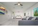 Spacious bedroom featuring a bed, a seating area, and large windows at 118 Wall St, Redington Shores, FL 33708