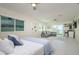 Bright bedroom featuring a bed, a sofa, and a large window with views of the water at 118 Wall St, Redington Shores, FL 33708