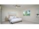 Cozy bedroom featuring a bed, side tables, and a window with view of a fenced yard at 118 Wall St, Redington Shores, FL 33708