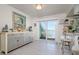 Bright dining area with a waterfront view through sliding glass doors, stylish decor, and a neutral color palette at 118 Wall St, Redington Shores, FL 33708