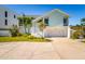 Charming two-story home with a two-car garage, white trim, well-maintained lawn, and inviting front entrance at 118 Wall St, Redington Shores, FL 33708