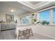 Stylish kitchen nook featuring bar seating, granite countertops, and ample natural light from the adjacent window at 118 Wall St, Redington Shores, FL 33708
