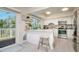 Bright kitchen with stainless steel appliances, white cabinetry, breakfast bar, and natural light from the outdoor access at 118 Wall St, Redington Shores, FL 33708