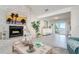 Well-decorated living room featuring a stone fireplace, modern furniture, and a sliding glass door to the outdoors at 118 Wall St, Redington Shores, FL 33708