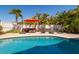 Relaxing poolside featuring outdoor furniture, a patio, and lush tropical landscaping at 118 Wall St, Redington Shores, FL 33708