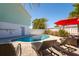 Inviting pool area with cozy lounge chairs and tropical foliage, perfect for relaxation at 118 Wall St, Redington Shores, FL 33708