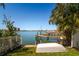 Picturesque waterfront featuring a private dock and boat lift with clear blue water at 118 Wall St, Redington Shores, FL 33708