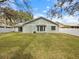 View of the home's backyard featuring a well-manicured lawn and a fence, offering privacy and security at 12 Ridgecroft Ln, Safety Harbor, FL 34695