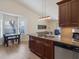 Kitchen features granite countertops, dark wood cabinets, and a stainless-steel dishwasher at 12 Ridgecroft Ln, Safety Harbor, FL 34695