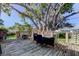 Backyard view featuring large deck, dining set, and mature trees, perfect for outdoor entertaining at 12694 138Th Ln, Largo, FL 33774