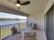 Relax on this balcony with comfortable seating and tranquil lake views at 12808 Boggy Creek Dr, Riverview, FL 33579