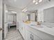 Bathroom featuring a double vanity, quartz countertop, and tile flooring, with a bedroom visible through door at 12808 Boggy Creek Dr, Riverview, FL 33579