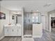 Bright bathroom featuring a modern glass shower, gray tiling, and white vanity with undermount sink at 12808 Boggy Creek Dr, Riverview, FL 33579