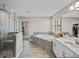 Beautiful bathroom featuring a glass shower and a large soaking tub at 12808 Boggy Creek Dr, Riverview, FL 33579