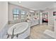 Bright bathroom featuring a soaking tub, double vanity, and elegant fixtures at 12808 Boggy Creek Dr, Riverview, FL 33579