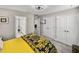 Bedroom featuring carpet, a black and yellow Versace-themed bed, and three white interior doors at 12808 Boggy Creek Dr, Riverview, FL 33579