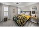 Cozy bedroom with plush carpeting, decorative bedding, round mirrors, and soft natural light at 12808 Boggy Creek Dr, Riverview, FL 33579