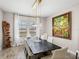 Elegant dining room featuring a large wood table, stylish lighting, and modern artwork at 12808 Boggy Creek Dr, Riverview, FL 33579