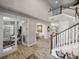 Open foyer features wood-look tile, a staircase, and views into the living and dining areas at 12808 Boggy Creek Dr, Riverview, FL 33579
