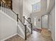 Grand foyer with high ceilings, wood-look tile flooring, staircase, and lots of natural light at 12808 Boggy Creek Dr, Riverview, FL 33579