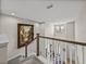 A sunlit foyer featuring soaring ceilings, elegant artwork, and a view of the front entry from the staircase at 12808 Boggy Creek Dr, Riverview, FL 33579