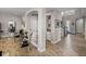 Elegant hallway with arched doorways, stylish decor, and hardwood floors at 12808 Boggy Creek Dr, Riverview, FL 33579