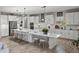 Modern kitchen with white cabinetry, stainless steel appliances, and a large center island at 12808 Boggy Creek Dr, Riverview, FL 33579