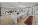 Open kitchen and living space with a large island, modern lighting, and seamless design at 12808 Boggy Creek Dr, Riverview, FL 33579