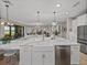 Open-concept kitchen with island, stainless appliances, and seamless flow to the living area at 12808 Boggy Creek Dr, Riverview, FL 33579