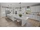 Stylish kitchen featuring a large island, modern pendant lighting, and white cabinetry at 12808 Boggy Creek Dr, Riverview, FL 33579