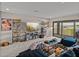 Cozy living room with modern decor, custom shelving, and sliding doors that lead to the balcony at 12808 Boggy Creek Dr, Riverview, FL 33579