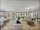 Spacious living room with water views, modern chandelier, and stylish furniture at 12808 Boggy Creek Dr, Riverview, FL 33579