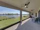 Relaxing screened lanai with comfortable seating overlooking the tranquil lake at 12808 Boggy Creek Dr, Riverview, FL 33579
