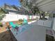 Backyard patio with outdoor furniture, a small garden, and a white privacy fence at 133 15Th Nw St, Largo, FL 33770