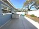 Relaxing backyard featuring a concrete patio and a charming Adirondack chair near a white fence at 133 15Th Nw St, Largo, FL 33770