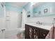 Charming bathroom featuring blue walls, shower-tub combination, and vanity with decorative mirror at 133 15Th Nw St, Largo, FL 33770