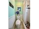 Cozy bathroom featuring a toilet and shower with decorative tiles at 133 15Th Nw St, Largo, FL 33770