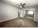 Bedroom features neutral walls, carpet flooring, a ceiling fan, and sliding closet doors at 133 15Th Nw St, Largo, FL 33770