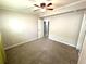 Bedroom features carpet, ceiling fan, window with curtain, closet, and electrical outlets at 133 15Th Nw St, Largo, FL 33770