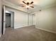 Bedroom features neutral carpet, ceiling fan, a window, and a mirrored sliding-door closet at 133 15Th Nw St, Largo, FL 33770