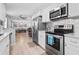Well-lit kitchen featuring stainless steel appliances and a seamless flow into the dining area at 133 15Th Nw St, Largo, FL 33770