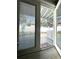 View from inside to the outdoor patio; view of fenced yard with outdoor furniture and garden at 133 15Th Nw St, Largo, FL 33770