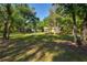 A vast green backyard surrounded by trees at 14114 N 301 Hwy, Thonotosassa, FL 33592