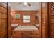 Bathroom showcasing a soaking tub, double vanity, and continuous wood-paneled design at 14114 N 301 Hwy, Thonotosassa, FL 33592
