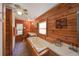 Bathroom with wood paneled walls and featuring a soaking tub and double sinks at 14114 N 301 Hwy, Thonotosassa, FL 33592