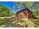 Side view of log cabin with a deck, showcasing the home's construction and outdoor space at 14114 N 301 Hwy, Thonotosassa, FL 33592